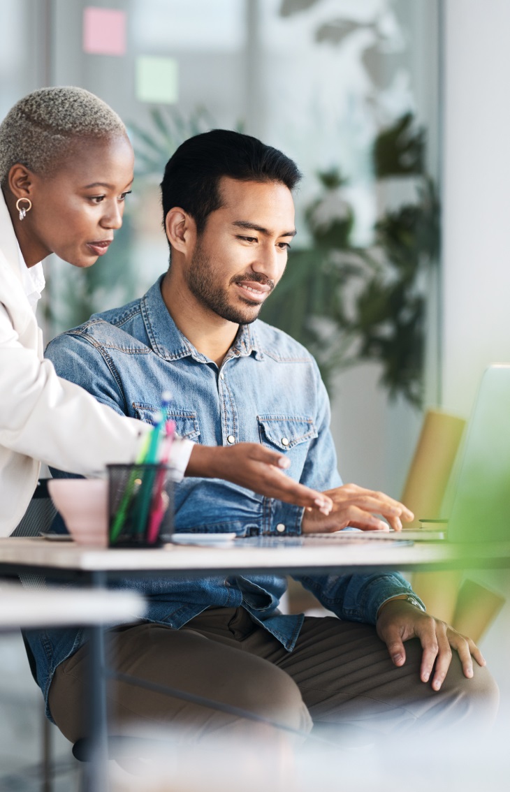 Woman and man using data extraction software on a laptop computer